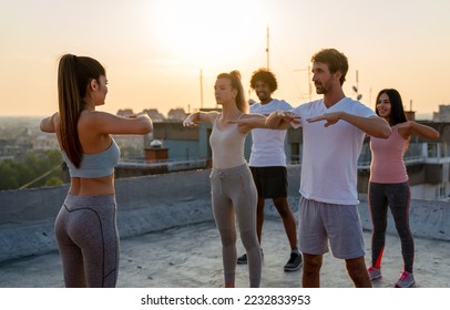 Group of fit healthy friends, people exercising together outdoor - Shutterstock ID 2232833953
