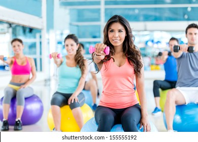 Group of fit people at the gym exercising