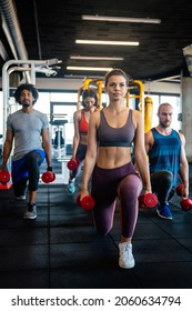 Group Of Fit People At The Gym Exercising