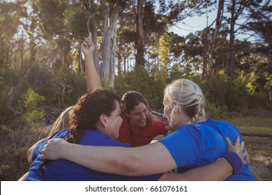Group of fit women forming huddles in the boot camp on a sunny day - Powered by Shutterstock