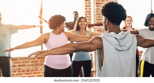 Group fitness class with diverse participants stretching. People in workout attire, exercising together. Fitness, exercise, and stretching in a bright studio. Diverse people in fitness class. - Powered by Shutterstock