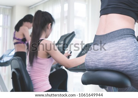 Group of Fitness woman is working out in fitness gym back view
