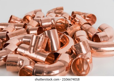 Group of fittings on a white background. Copper fittings for pipe connections. Technical basis for heating companies.