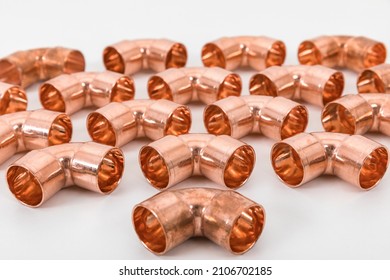 Group of fittings on a white background. Copper fittings for pipe connections. Technical basis for heating companies.