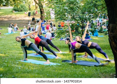 Group Of Five Adults Female Spoty Women Attending A Yoga Class Outside In Park. Fitness, Sport, Yoga And Healthy Lifestyle Concept.