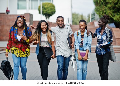 Group Of Five African College Students Spending Time Together On Campus At University Yard. Black Afro Friends Studying. Education Theme.