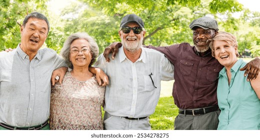 Group of five diverse seniors enjoying a sunny day in the park. Smiling seniors, diverse seniors, happy seniors, enjoying nature together. Group of diverse elderly people smiling. - Powered by Shutterstock