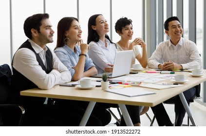 Group of five diversity businessmen, two men and three women sitting at meeting desk and pay attention for speaker of the conference - Shutterstock ID 1913522272