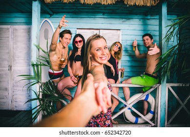 Group Of Five Friends Celebrating In Their Summer Beach House