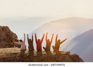 Group of five happy friends having fun at mountain top