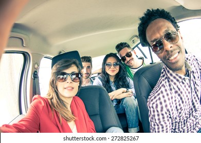 Group Of Five People Driving To Vacation And Taking A Selfie In The Car - Happy People Of Of Diverse Ethnics In An Automobile - Friends Renting A Car And Driving Somewhere