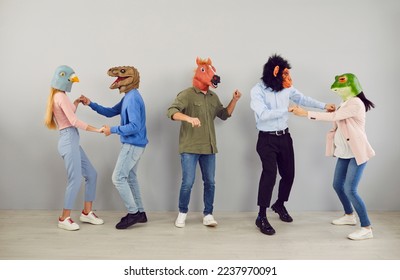 Group of five strange people in animal disguise dancing and having fun together. Team of young men and women wearing funny wacky animal masks having fun at crazy party - Powered by Shutterstock