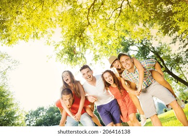 Group Of Five Teenage Friends Having Fun In Park