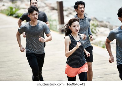 Group Of Five Young Asian Adult Men And Woman Running Training Outdoors