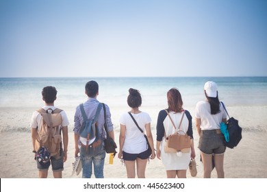 A Group Of Five Young Teenager Friends Travel To The Beach Looking At The Sea