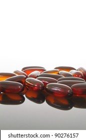 Group Of Flaxseed Oil Pills On A Glass Table.