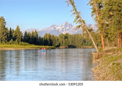 A Group Floats A Raft Down The Snake River In The Grand Tetons National Park.