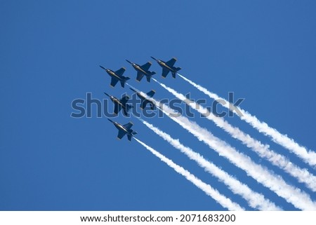 A group of flying aircraft against a clear sky during the National Air Show in Cleveland, USA