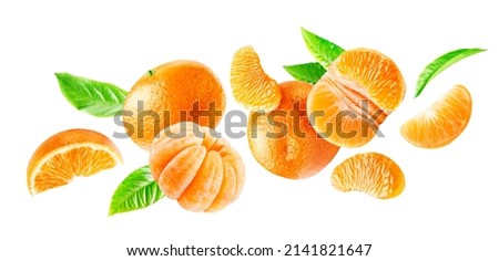 Group of flying ripe mandarins whole and peeled with leaves isolated on a white background.