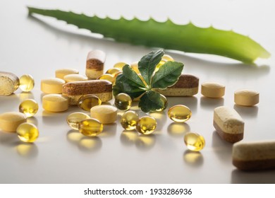 A group of food additives diffrent shape and colors with green leaf on  white background. As a concept of natural medicines. Preventive medicine. Prevention of coronovirus.