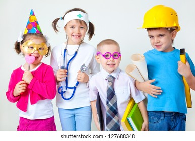Group Of Four Children Dressing Up As Professions