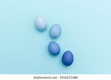 Group of four colored easter eggs in shades of blue