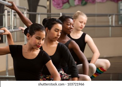 Group of four diverse ballet dancers warm up - Powered by Shutterstock