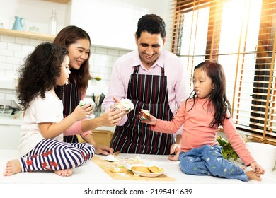 Group Of Four Diverse Family, Asian And Arab Preschool African Arab Kid Person Make Cake Cooking In Kitchen, Father Mother Prepare Decoration Pretty With Fun Educate. Cream Mess Over Face, Copy Space