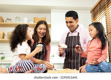 Group Of Four Diverse Family, Asian And Arab Preschool African Arab Kid Person Make Cake Cooking In Kitchen, Father Mother Prepare Decoration Pretty With Fun Educate. Cream Mess Over Face, Copy Space