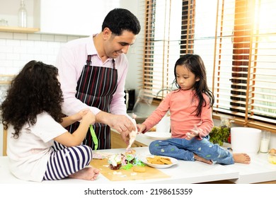 Group Of Four Diverse Family, Asian And Arab Preschool African Arab Kid Person Make Cake Cooking In Kitchen, Father Mother Prepare Decoration Pretty With Fun Educate. Cream Mess Over Face, Copy Space