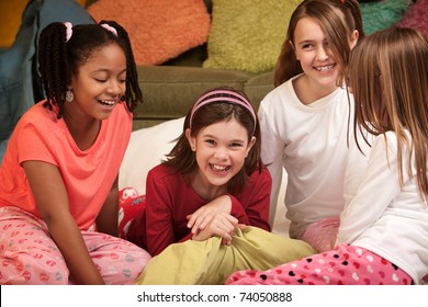 Group Of Four Happy Little Girls At A Sleepover