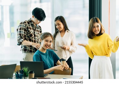 Group Of Four Happy Young Asian Corporate People Teammates Meeting Discussing Business In Office.