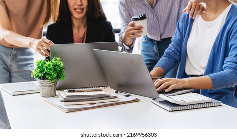 group of four happy young asian corporate people teammates meeting discussing business in office. - Shutterstock ID 2169956303
