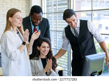 Group Of Four Professional Multiethnic Businessmen And Businesswomen Employee Gathered In Front Of Desktop Computer Clapping Their Hands With Happiness To Celebrate Successful Business Conference