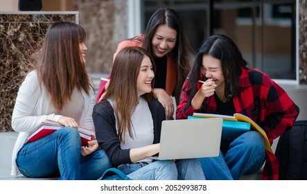 Group Of Four Young Attractive Asian Girls College Students Studying Together Using Laptop In University Campus Outdoor. Concept For Education, Friendship And College Students Life.