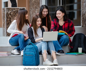 Group Of Four Young Attractive Asian Girls College Students Studying Together Using Laptop In University Campus Outdoor. Concept For Education, Friendship And College Students Life.