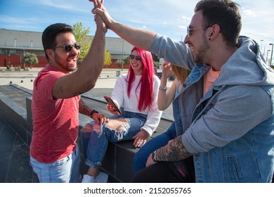 Group Of Four Young Friends Greeting Each Other