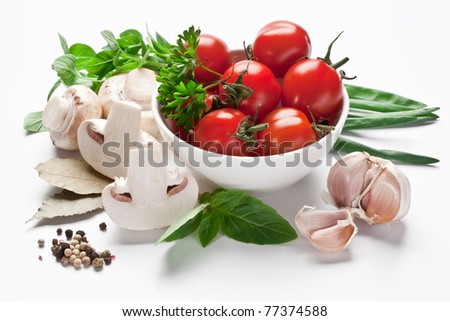 Group of fresh vegetables and tomatoes isolated on a white.