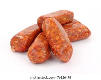 A Group Of Freshly Made Hot Italian Sausage Links On A White Background.