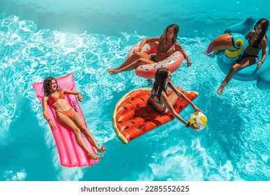 Group of friend play together in the swimming pool - Powered by Shutterstock