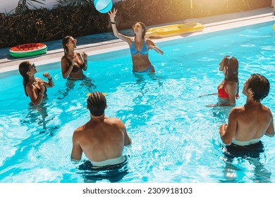 Group of friend play together in the swimming pool