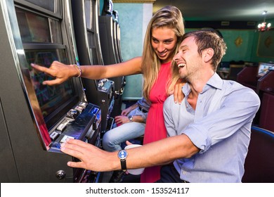 Group Of Friend Playing With Slot Machines