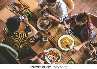 Group Of Friend Take A Picture With Mobile Phone Before Having Nice Food And Drinks, Enjoying The Party And Communication, Top View Of Family Gathering Together At Home For Eating Dinner.