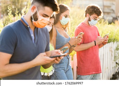 Group Friend Wearing Face Mask For Covid – Young People Using Mobile Phone Wearing Surgical Mask – Teenagers Hangout Using Smart Phone 