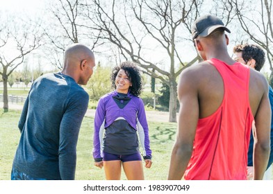 Group Of Friendly Runners Talking In A Park Before Training.