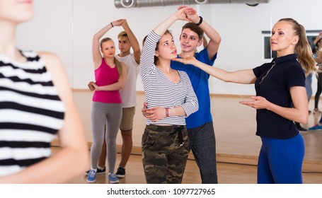 Group Of Friendly Teenagers Learning To Dancing Tango In Dance Studio