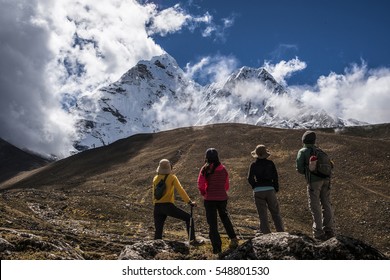 Group of friends admiring Himalaya range on Everest base camp trek.