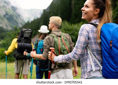 Group of friends with backpacks doing trekking excursion on mountain - Shutterstock ID 1990705541