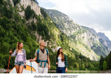 Group of friends with backpacks doing trekking excursion on mountain - Shutterstock ID 2089522357