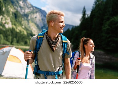 Group of friends with backpacks doing trekking excursion on mountain